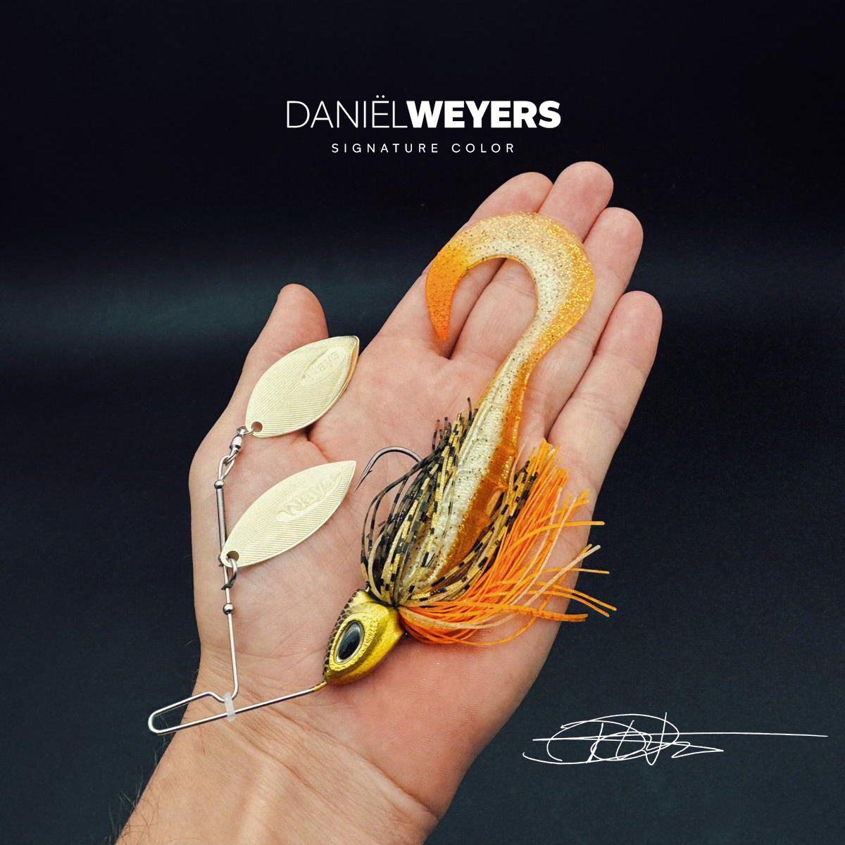 Nays MZ RNNR 2.0 L 18 - Daniel Weyers Spinnerbait mit goldenen Blättern, orange-schwarzem Rock und glitzerndem Trailer, designed zum Jubiläum von Daniel Weyers.