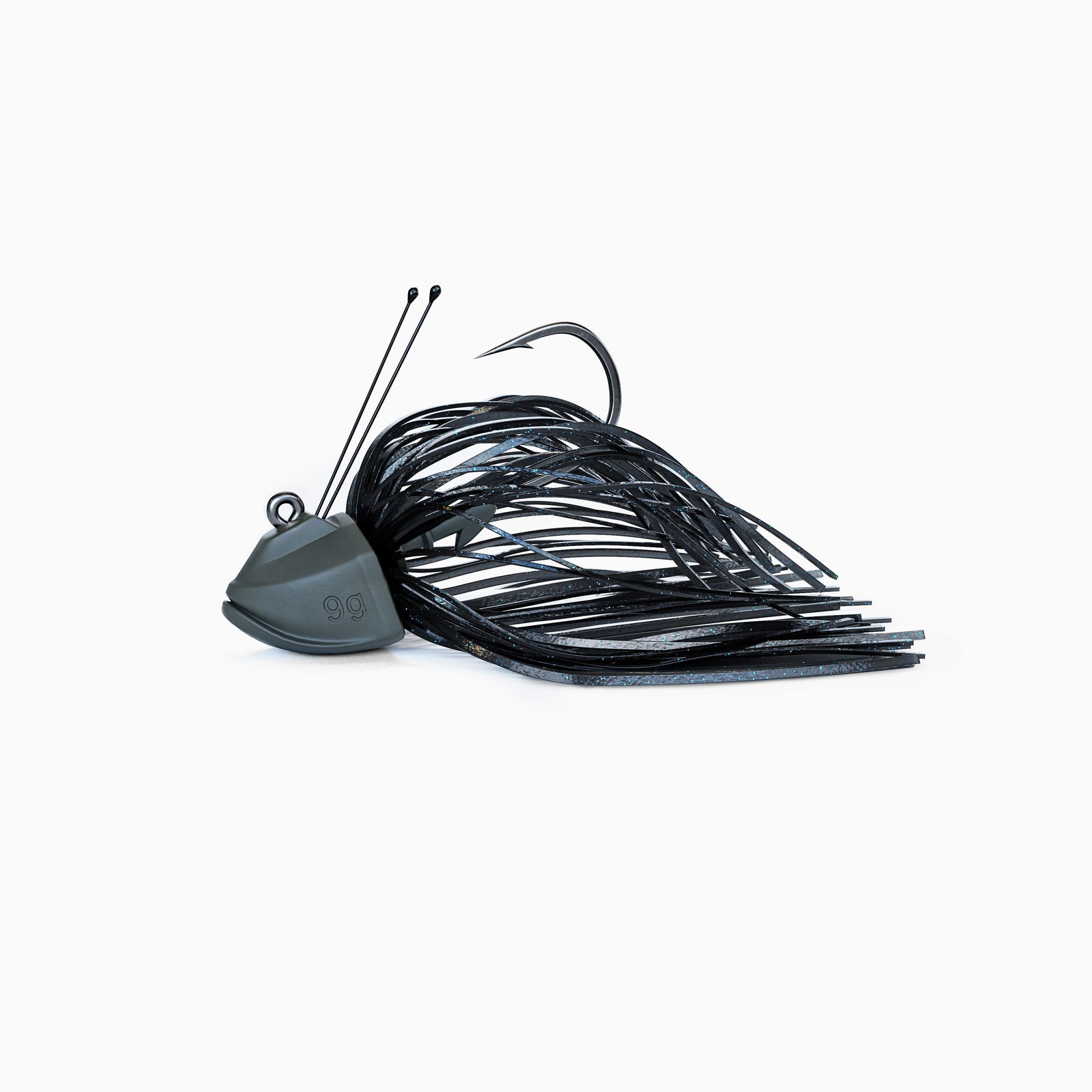 Das Bild zeigt einen Skirted Jig mit einem Tungsten-Kopf und Krautschutz aus Titandraht. Ein Fransenkleid in schwarz mit Glitzer Partikeln umschließt den scharfen BKK Einzelhaken.