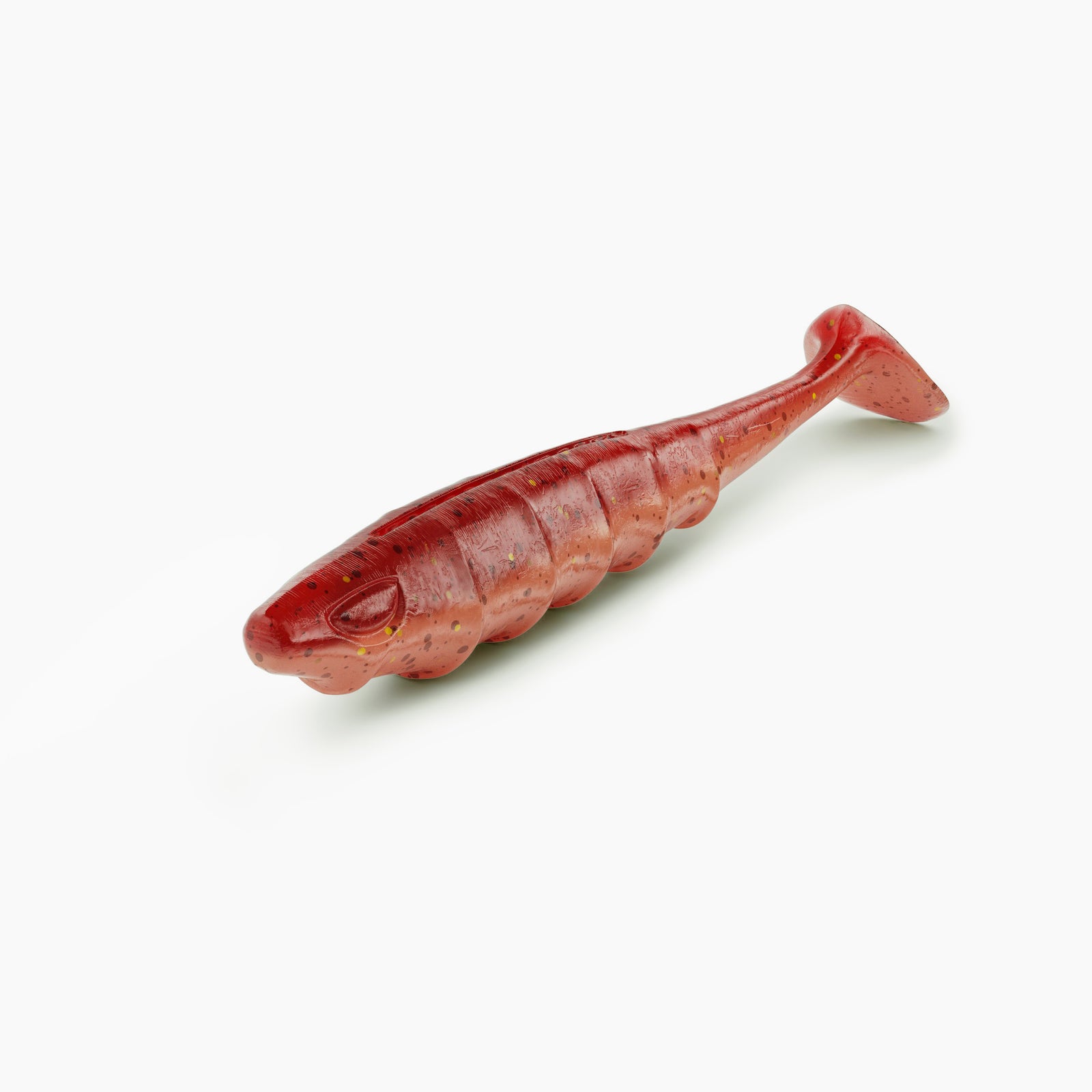 Das Bild zeigt einen Paddle-Tail-Gummiköder mit realistischem Augen-Design und typischer Rippenstruktur. Der Körper ist im auffälligen Rot gehalten, während der Bauch einen helleren Kontrast mit dunkleren und Partikeln bildet.