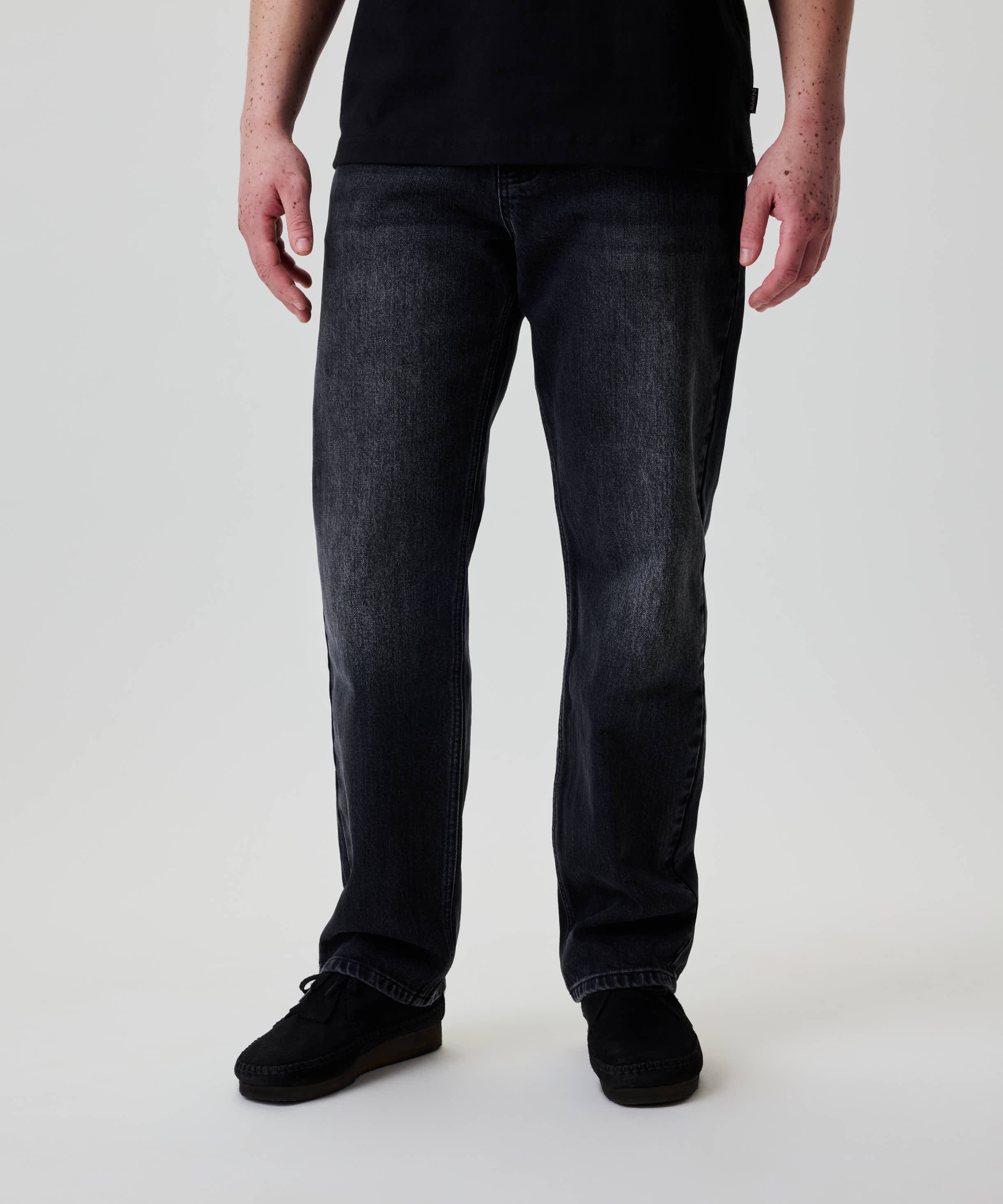 Nays Regular Fit Jeans in dunklem Denim, gerade geschnitten mit 5-Pocket-Design. Gesehen mit schwarzen Schnürschuhen, bieten Komfort und Bewegungsfreiheit durch Elasthananteil.